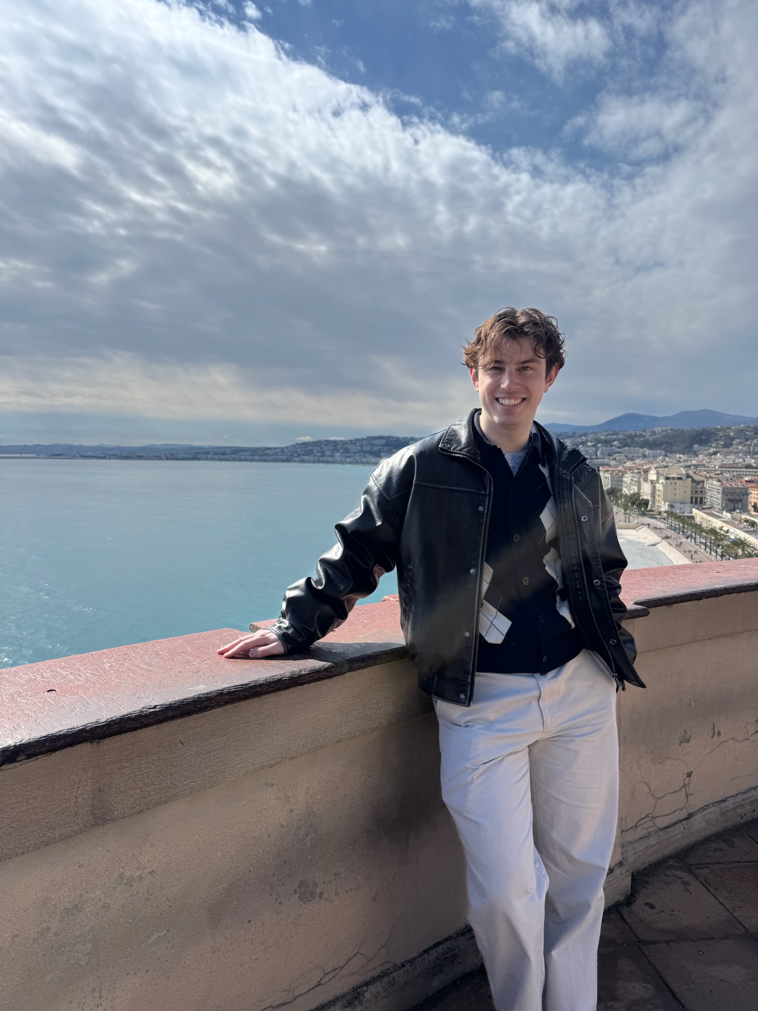Andrew Hadden smiling beside the coast